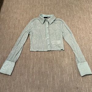 It’s a beautiful sequin shirt from Rotate in perfect condition.